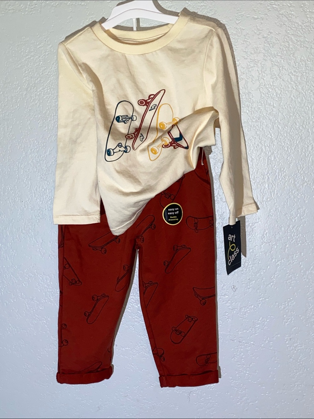 art class Cream Tee with Multicolor Skateboard Graphic & Rust Pants